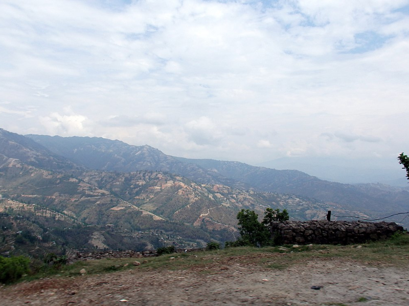 Hiker enjoying the scenic trail from Nagarkot to Dhulikhel on an easy hike in Nepal.